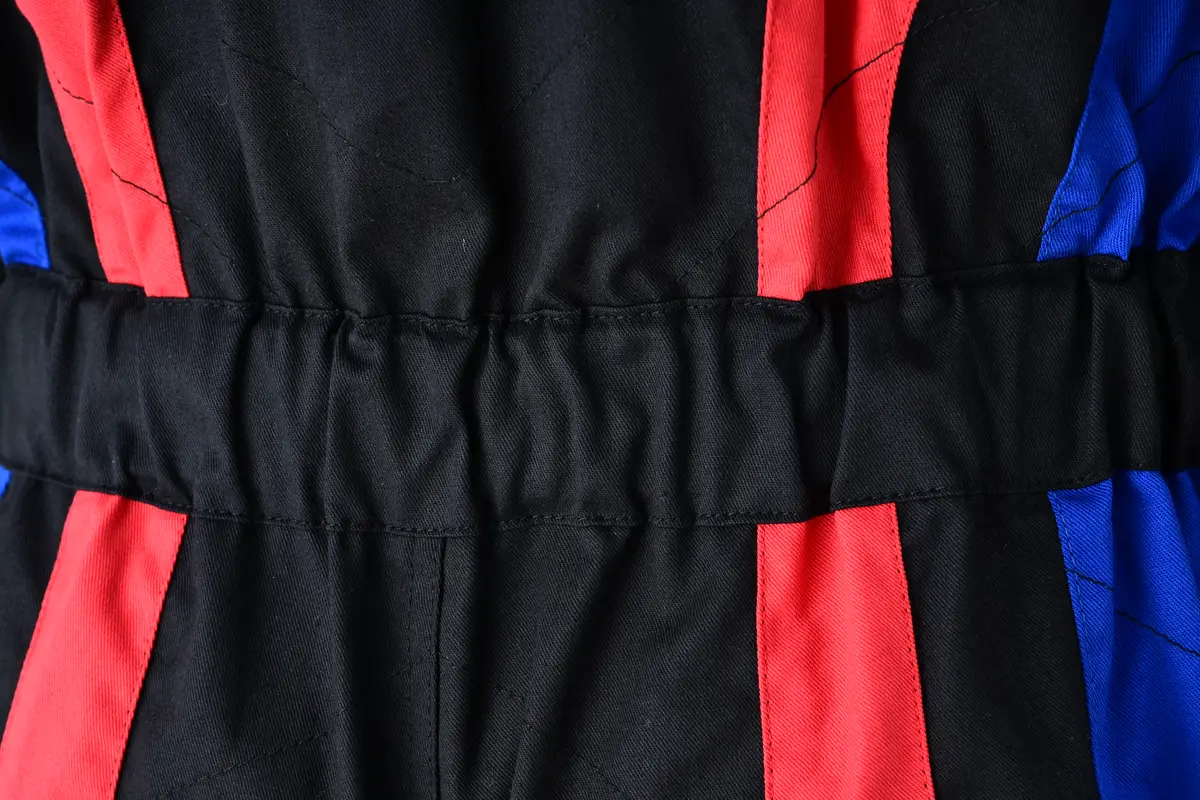 Close-up of the elasticated back waist and panel stitching on a black racing suit